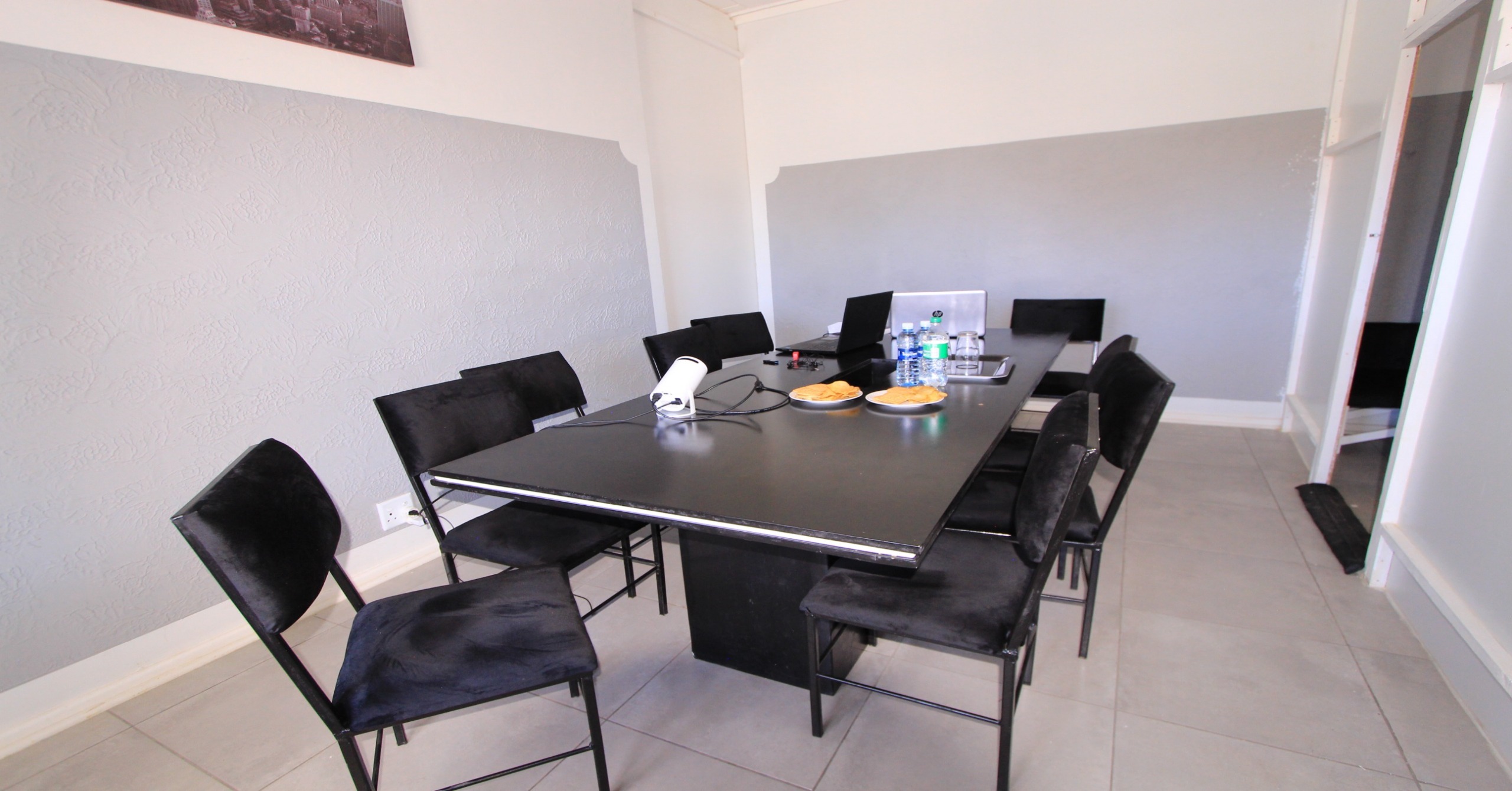 Tenebix meeting room with a shared table, chairs and presentation equipment